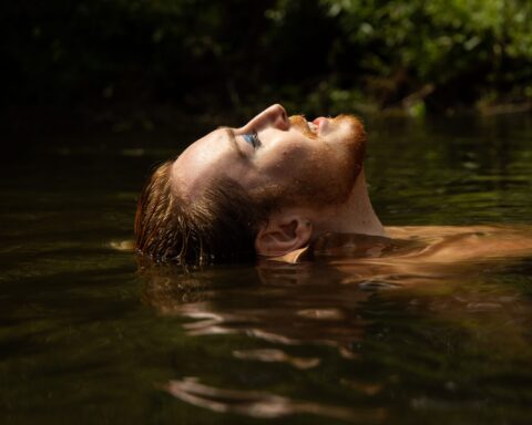Promotional photo for "Found My Person" which is a side-shot of Blair Davie as they are submerged half in water with their face looking up to the sky.