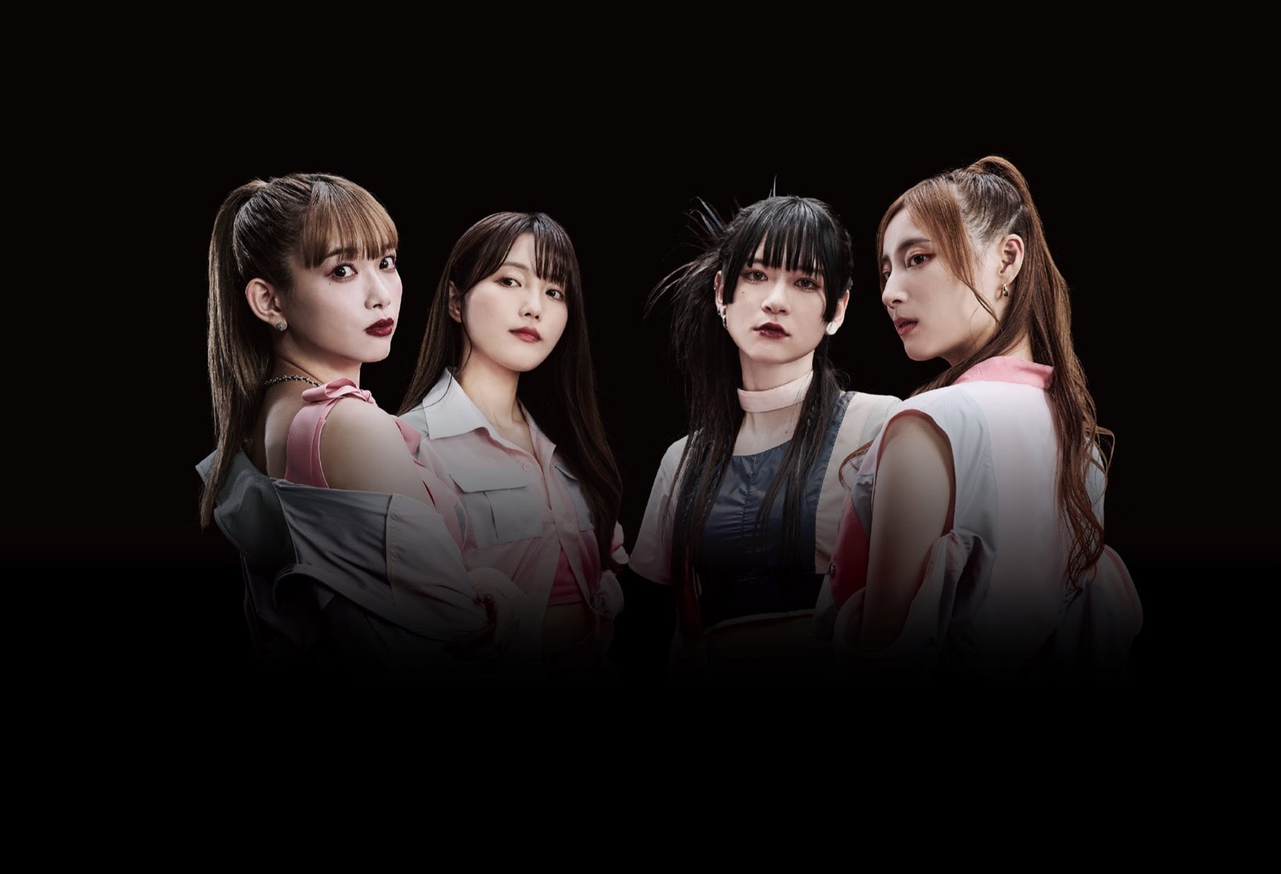 Promotional photo for "GROUNDSWELL" which sees the four band members of PassCode surrounded by darkness while their faces are spotlighted, with two of the women looking at the camera over their shoulders.