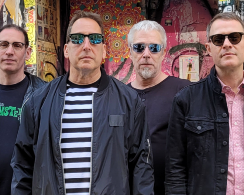 Promotional photo for "Good Girl" which sees The Underbites posing for a band picture. All four members are lined up, all facing the camera, all wearing sunglasses.