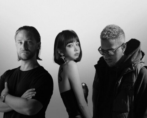 A black-and-white Photoshopped press picture for "The Ones We Lost" which sees Brandon Beal on the left wearing a black t-shirt, Lizzy Wang in the middle side-on and wearing a tube dress with her hair in a bob and tucked behind her ear, then HEGEGAARD is on the right looking down and wearing a big thick coat.
