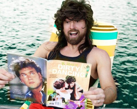 Promotional photo for "Swayze" which sees Iglu & Hartly frontman, Jarvis Anderson, in a wig, lying on a deck chair, reading a Dirty Dancing magazine.